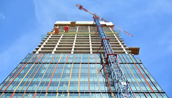 A crane is in front of the building.