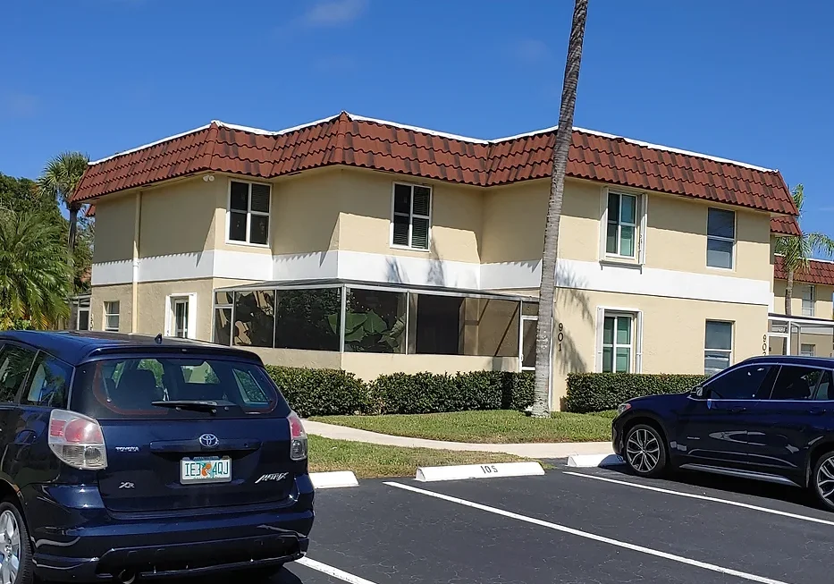 A car parked in front of a building on the side of a street.